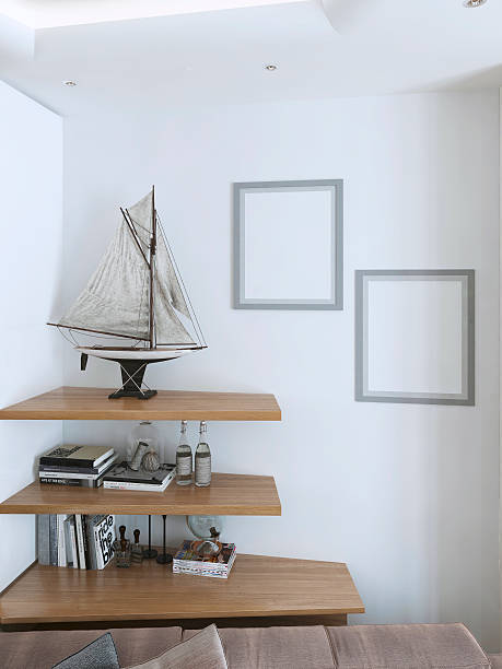 istock Suspended wooden shelves with decorative items for the interior. 590134524