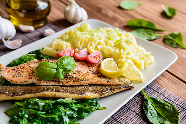 istock Baked trout fillet with mashed potatoes and steamed spinach 590134752