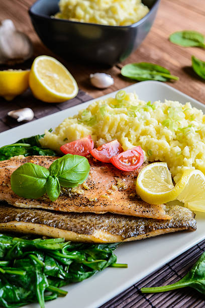 istock Baked trout fillet with mashed potatoes and steamed spinach 590134834