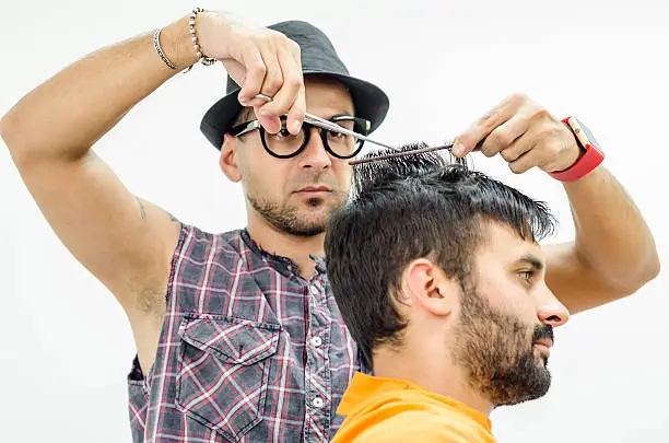 Photo of hairdresser cuts a customer piece of hair