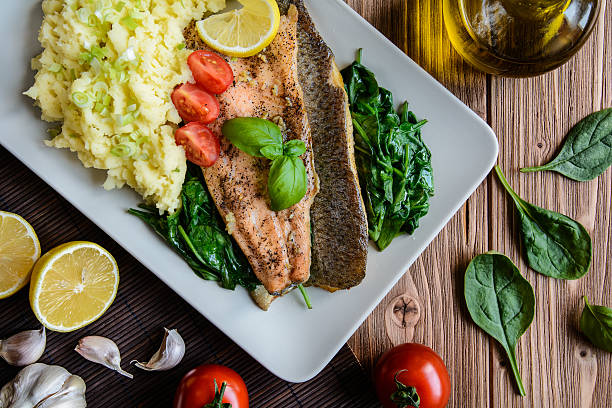 istock Baked trout fillet with mashed potatoes and steamed spinach 590135006