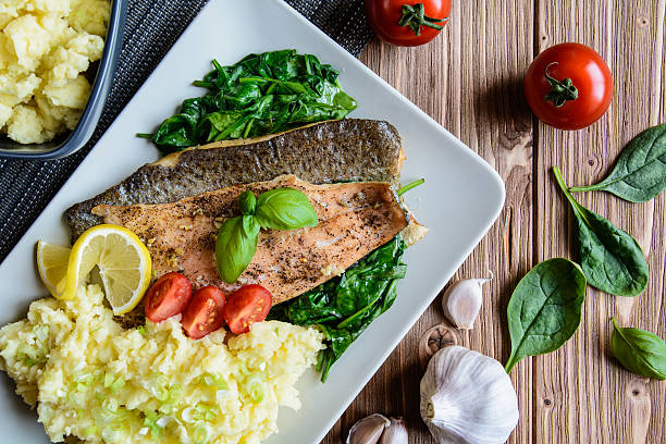 Baked trout fillet with mashed potatoes and steamed spinach