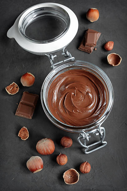 istock Chocolate hazelnut spread or nuts butter in a glass jar 590135412