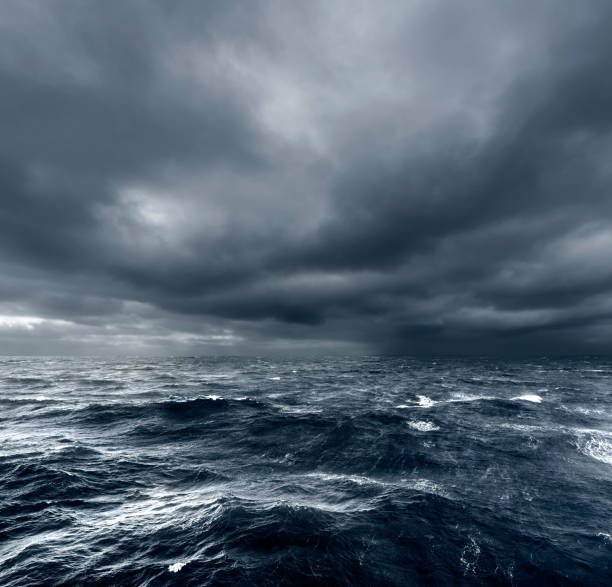 intense thunderstorm rolling over open ocean - tempestade imagens e fotografias de stock
