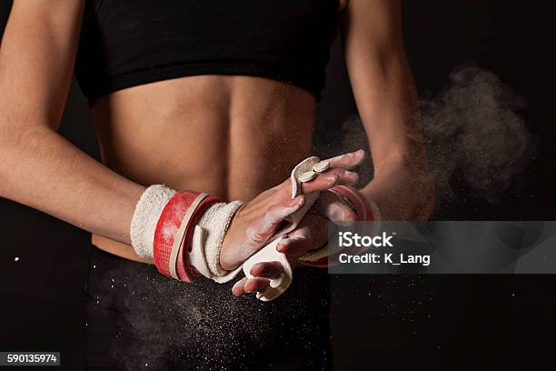 Artistic Gymnast Chalking Up Grips For Uneven Bars Stock Photo - Download Image Now - Artistic Gymnastics, Gymnastics, Close-up