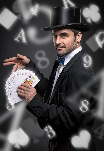istock Magician performing trick with playing cards 590136066