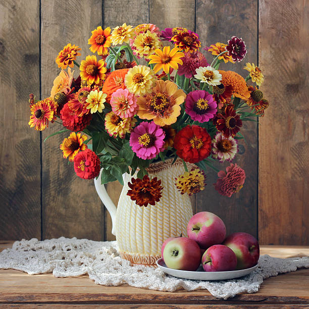 istock Still life with a bouquet and apples. 590136602