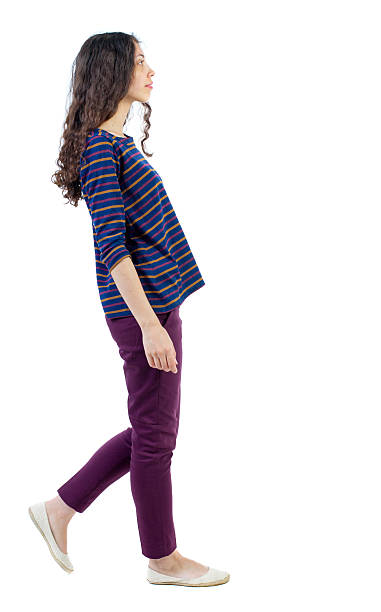 istock back view of walking  curly woman. 590139508