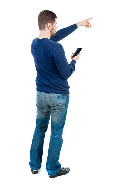 istock Back view of  pointing young men talking on cell phone. 590139760