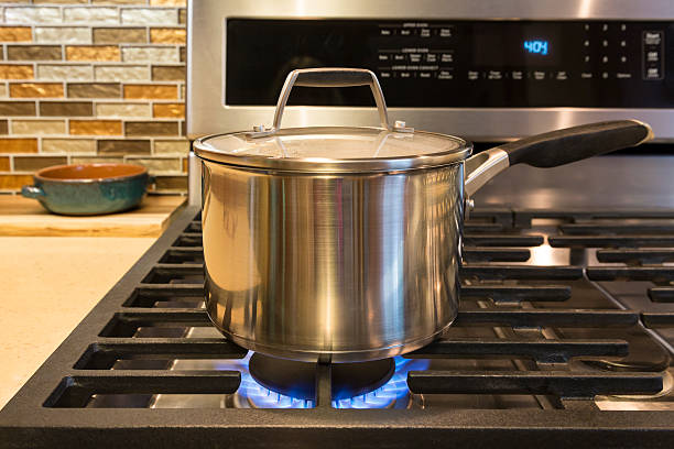 istock Cooking pot on gas stove in contemporary upscale home kitchen 590141978