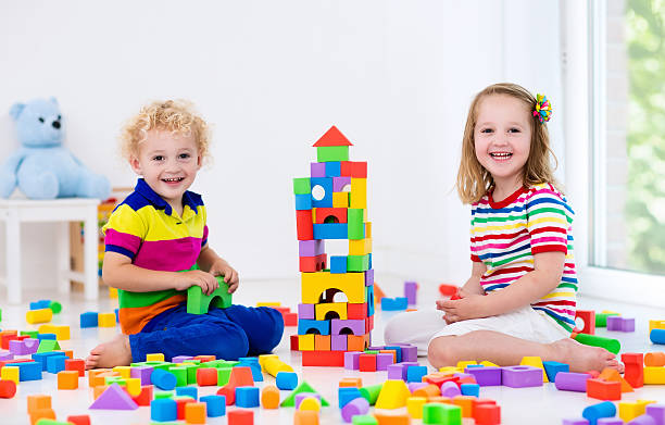 istock Kids playing with colorful plastic toy blocks 590142056