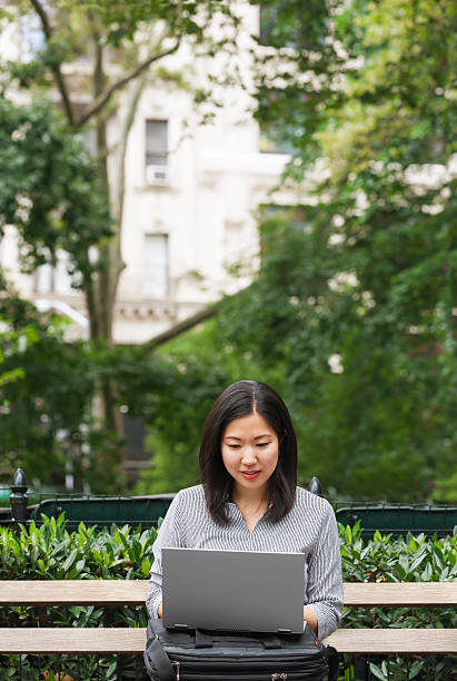 istock Working businesswoman sitting on park bench 590143986