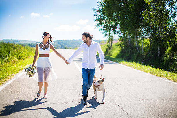 istock Bride and groom in beautiful nature with dog 590144622