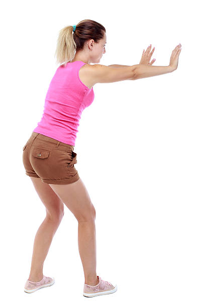 istock back view of woman pushes wall. 590145302