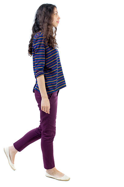 istock back view of walking  curly woman. 590145558