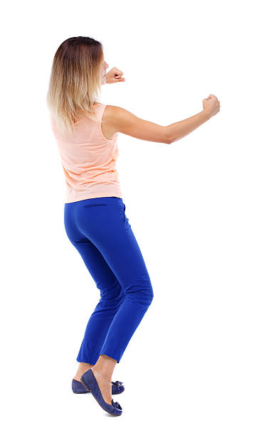 istock back view of standing girl pulling a rope from top 590145658