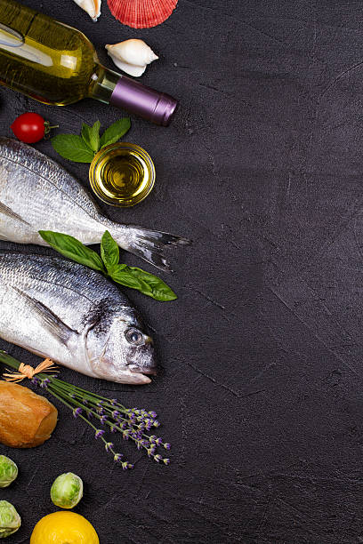 istock Raw fresh dorado fish with fruits and vegetables 590146490