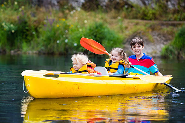 istock Happy family with three kids kayaking on a river 590149542