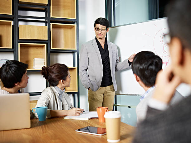 istock young asian business person facilitating a discussion 590149598