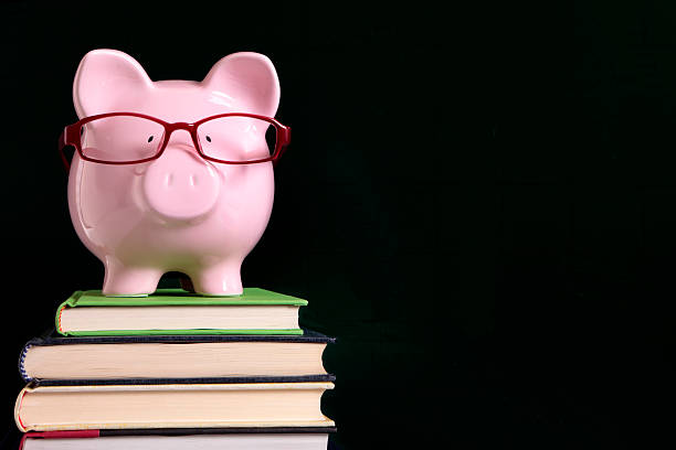istock Piggybank with glasses and blackboard 590151744