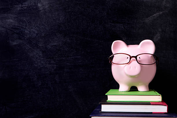 istock Piggybank with glasses and blackboard 590151830