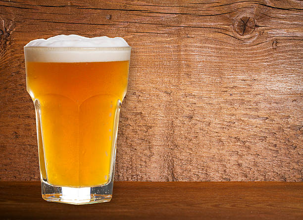 istock Beer on Old Wooden Shabby Background Close Up 590153090