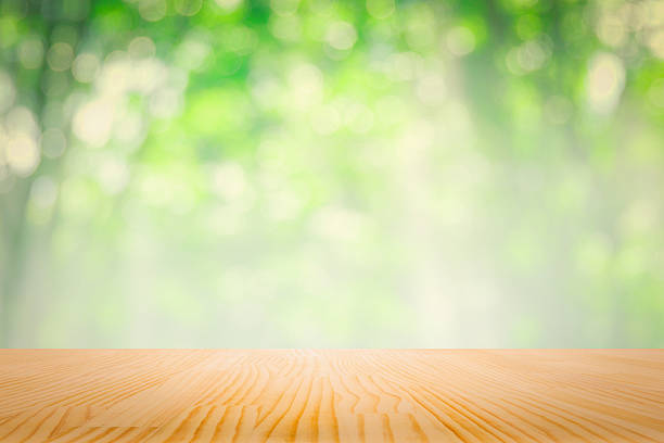 istock Top wooden table with nature soft green leaf background abstract 590153488