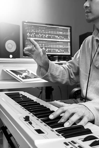 istock asian handsome musician playing keyboard in recording studio 590154716