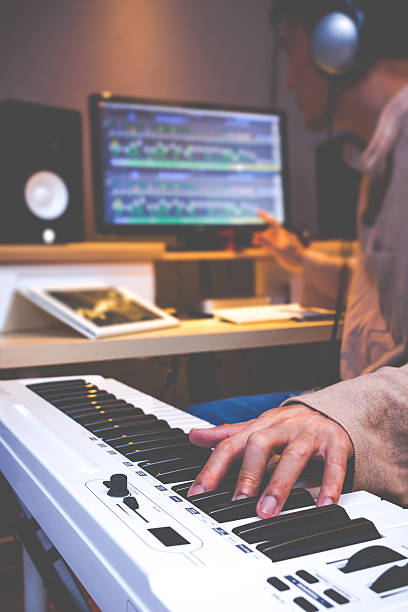 istock asian songwriter composing song in recording studio 590154972