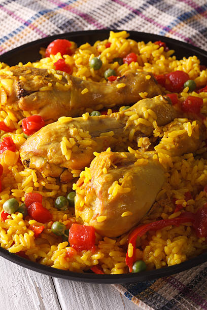 istock Paella with chicken legs and vegetables close-up. Vertical 590155262