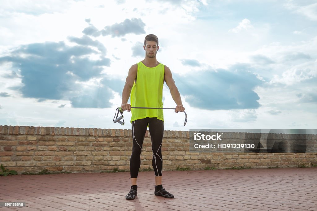 Young man fitness resistance band training stretching Young man fitness resistance band training stretching sky 20-29 Years Stock Photo
