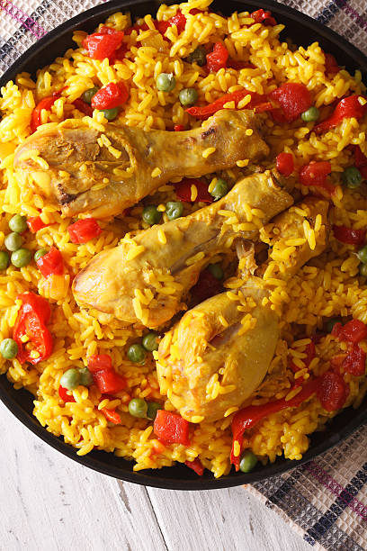 istock paella with chicken and vegetables close-up. vertical top view 590156132
