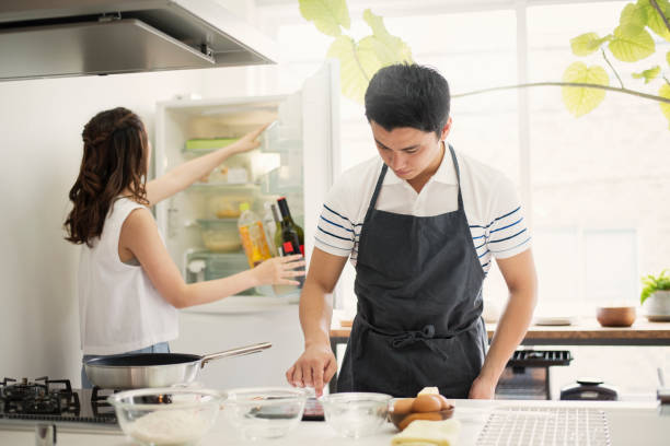 Young couple looking at the recipes in the digital tablet