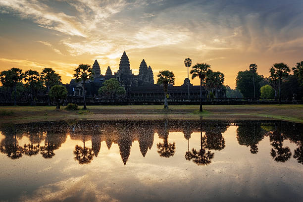 istock Angkor Wat reflected in lake at dawn. Siem Reap, Cambodia 590156756