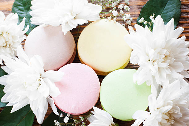 istock Colorful macaroon in white blossom frame, close-up 590158678