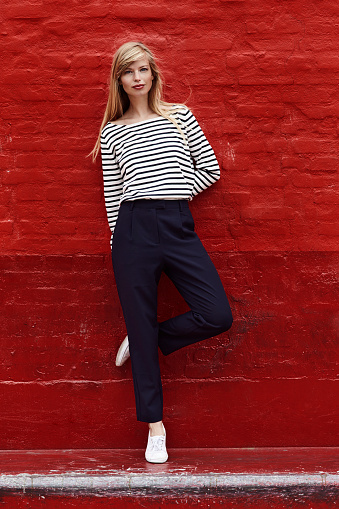 Portrait of gorgeous model against red wall