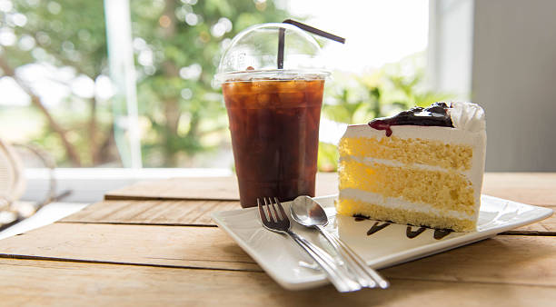 istock Ice coffee and blueberry cake on wood table, 590162024