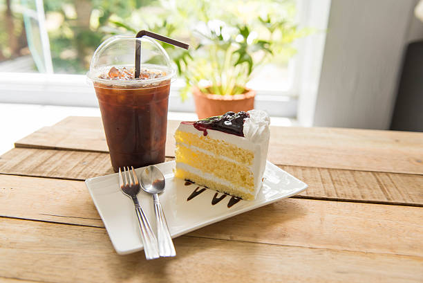 istock Ice coffee and blueberry cake on wood table, 590162056