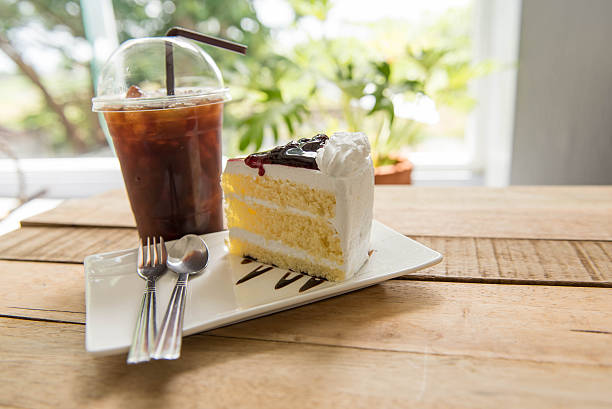 istock Ice coffee and blueberry cake on wood table, 590162086