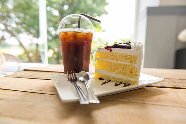 istock Ice coffee and blueberry cake on wood table, 590162128