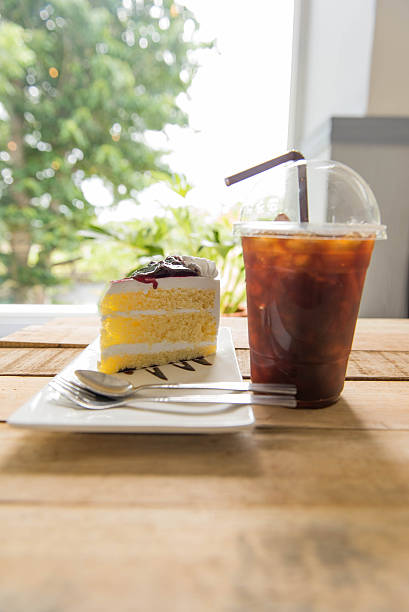 istock Ice coffee and blueberry cake on wood table, 590162154