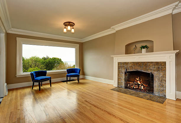 istock Empty living room interior with fireplace and blue armchairs. 590162158