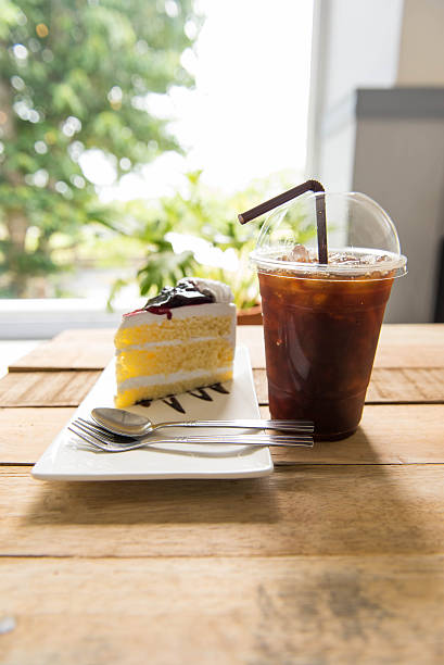 istock Ice coffee and blueberry cake on wood table, 590162182