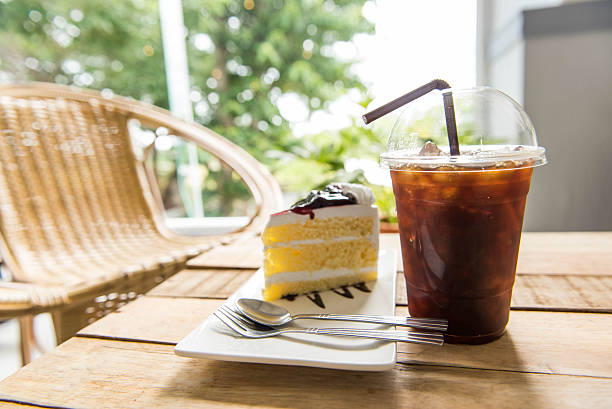 istock Ice coffee and blueberry cake on wood table, 590162222