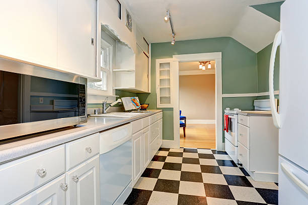 istock Classic kitchen room interior with blue walls and white cabinets 590162734