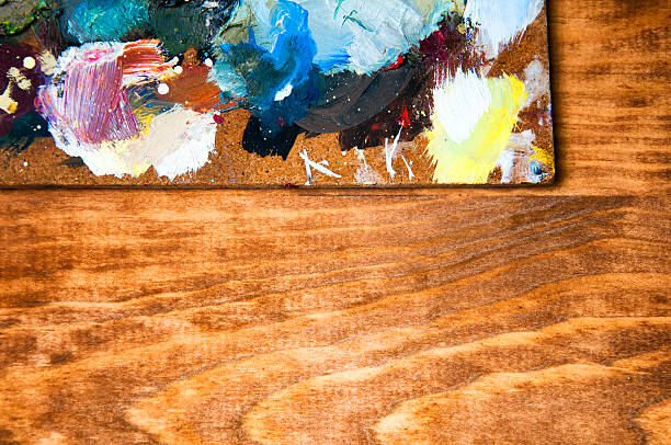 istock Painting palette on wooden background 590162838