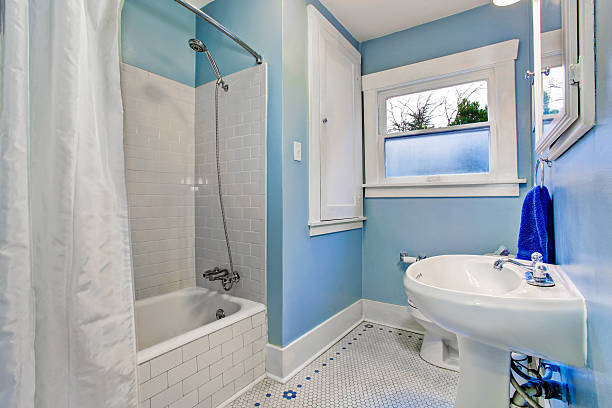 istock Bathroom interior in light blue tones with shower bath tub 590163066