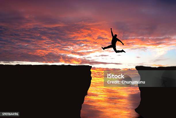 Jumping Into Cliff Gap Stock Photo - Download Image Now - Jumping, Canyon, Ravine