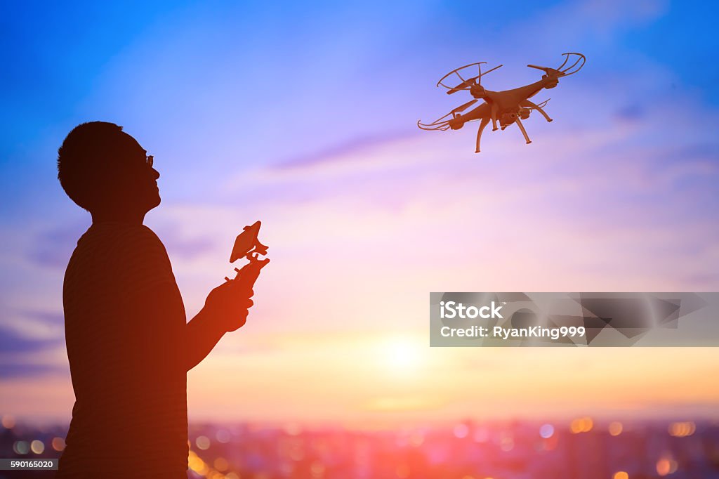 silhouette of man take drone silhouette of man play drone in the sunset, asian Drone Stock Photo