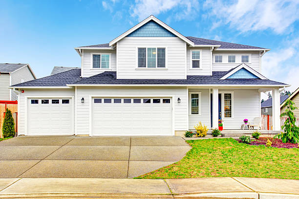 istock Luxury two level house exterior with garage and concrete driveway. 590165988